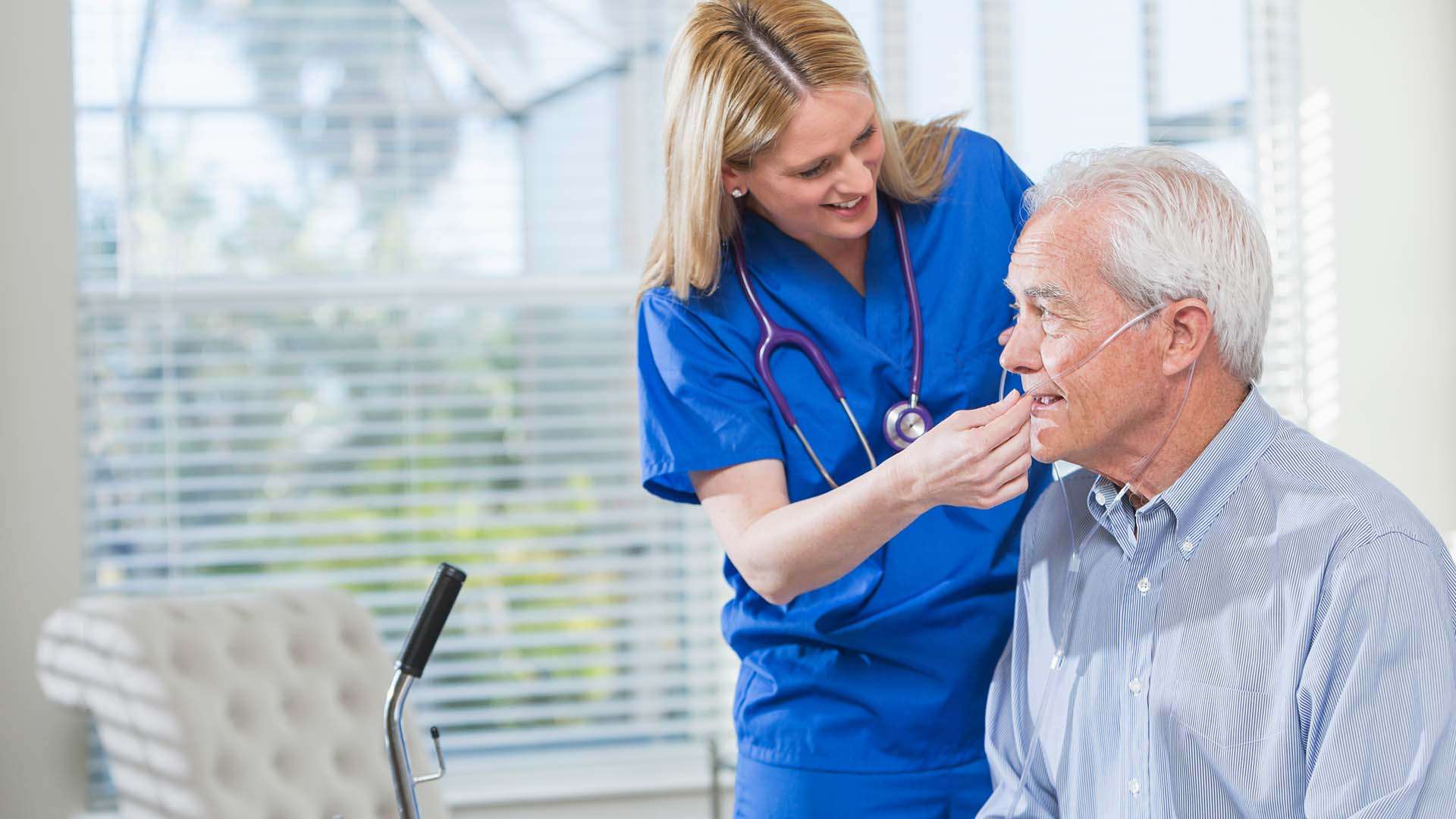 nurse helping man with oxygen