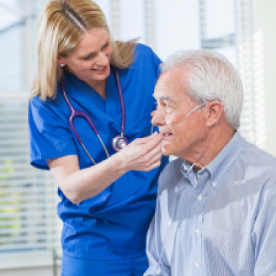 nurse helping man with oxygen